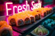 Fresh Sushi California Rolls with Neon Sign on Black Plate