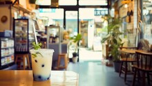 A Refreshing Iced Bubble Tea With A Sprig Of Mint In A Casual Trendy Cafe Setting.