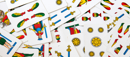 Spanish-suited playing cards. The Neapolitan pattern widely used in central and southern Italy. Zenith view on bulk playing cards. Ideal for background or backdrop. Card games.