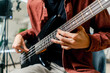 © Guys Who Shoot - musician with electric guitar in recording studio plays musical instrument presses fingers on strings close-up