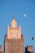 Top part of Ministry of Foreign Affairs of Russian Federation building in Moscow and the full moon on cloudless sky in the evening