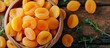 Healthy food, vegetarianism, and vitamins are the concept of the banner which showcases plenty of beneficial dried apricots in a wooden bowl from a top perspective on a website.