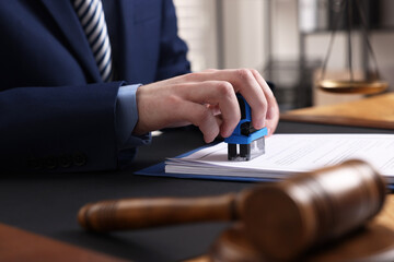 Sticker - Notary stamping document at table in office, closeup