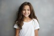 © KLEEM - portrait of a 10 year old girl smiling on a gray background