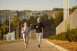 © Studio Romantic - Senior couple enjoys the benefits of running and jogging together in a city park. Smiles and shared sport enthusiasm showcase the joy and fulfillment found in staying active and fit with run and jog.