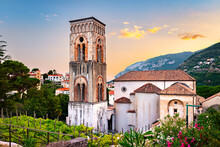 Ravello, Italy. Breathtaking Sunset Over The Cathedral Of Santa Maria Assunta And Its Bell Tower Framed Between Plants And Colorful Oleander Flowers.