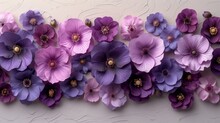 A Group Of Purple And Purple Flowers On A White Wall With A Pattern Of Flowers On The Side Of The Wall.