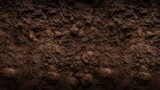 Fototapeta  - A background texture of rich dark brown soil