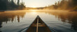 erene canoeing on a misty lake at dawn, paddle cutting through water, wide shot for a sense of adventure and tranquility