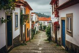 Fototapeta Uliczki - A charming European street with narrow cobblestones and buildings in shades of white and orange, Quaint houses and narrow streets of a Portuguese village, AI Generated