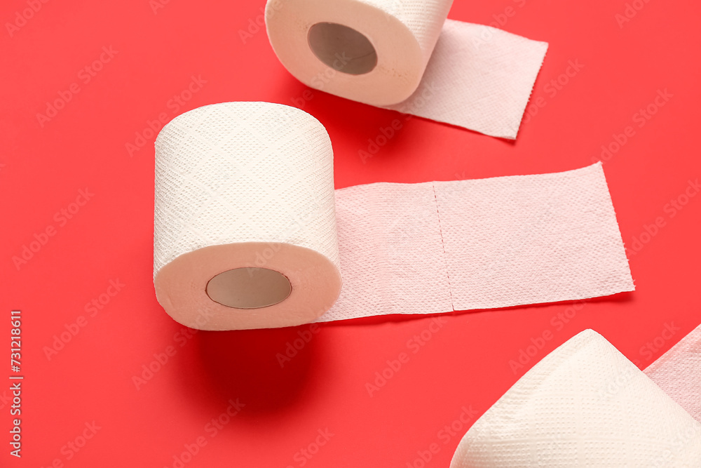 Rolls of toilet paper on red background