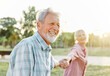 woman man senior couple happy retirement together elderly active vitality park fun smiling love old nature wife happiness mature walking holding hands