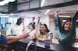© BullRun - Excited diverse coworkers celebrating success drinking beverages