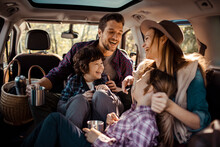 Young Family Laughing On A Car Road Trip