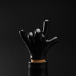 © cosmoman - Thief cartoon hand showing horns or rock gesture isolated over black background. 3d rendering.