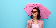 Friendly Woman Holding Bright Pink Umbrella On Solid Pastel Blue Background With Copy Space For Lifestyle Concept