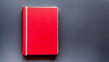 Red Closed Book With Blank Hard Cover On Background Top View Space For Text