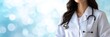 © Ilja - Experienced female doctor with stethoscope in hospital on blurred magical background with text space
