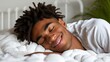 © Ilja - Blissful african american man peacefully sleeping on a white bed with a white blanket