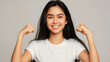 © Nemanja - A beautiful young teenage Caucasian girl with black hair, wearing a white t shirt, smiling at the camera with white teeth and flexing her muscles. Strong youthful female teen, strength and health