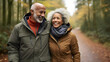 © Annemarie - afro american elderly senior couple walking together in autumnal forest. retirement enjoying