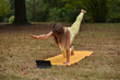 © Natalje Dietrich - A middle-aged woman is doing yoga in the park