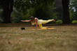 © Natalje Dietrich - A middle-aged woman is doing yoga in the park