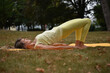 © Natalje Dietrich - A middle-aged woman is doing yoga in the park