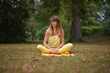 © Natalje Dietrich - A middle-aged woman is doing yoga in the park