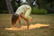 © Natalje Dietrich - A middle-aged woman is doing yoga in the park