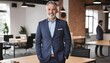 © Antonio Giordano - Mature businessman standing in a co-working space