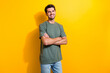 Portrait of handsome optimistic guy with stubble wear stylish t-shirt standing hold arms crossed isolated on yellow color background