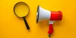 Megaphone and magnifying glass on yellow background, marketing concept