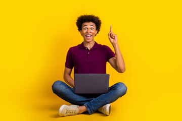 Sticker - Photo of funny cheerful glad crazy clever man sitting floor finger up great solution decision isolated on yellow color background