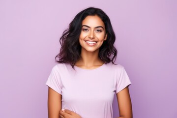 Wall Mural - Portrait of happy smiling young woman in casual clothes, over violet background