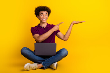 Sticker - Photo of positive man wear stylish magenta polo sit floor demonstrates empty space discount proposition isolated yellow color background