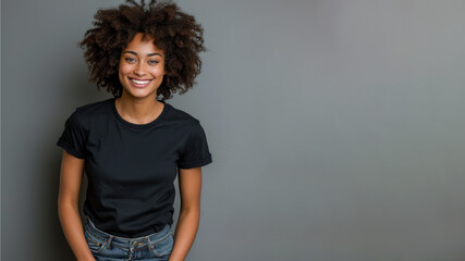 Wall Mural - Afro young woman wear black t-shirt smile isolated on grey background