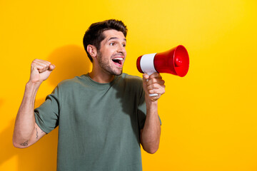 Sticker - Portrait of handsome guy with stubble wear stylish t-shirt scream in loudspeaker look empty space isolated on yellow color background