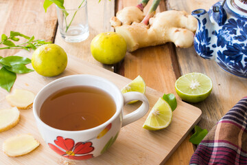 Wall Mural - herbal drink lemon ginger tea for health care on background wooden