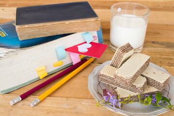 milks, wafer dessert snack and book of lifestyle student arrangement flat lay style on background white