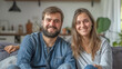 © Olya Fedorova - Cute couple, guy and girl sitting on the sofa