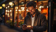 © kura - a happy male using a smartphone on the street