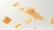 © buraratn - Parmesan cheese flying in different directions with crumbs on a white background with space for the text.