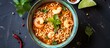 Top-down view of spicy shrimp instant noodle soup in a flat arrangement.