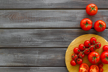 Wall Mural - Tomatoes and basil on wooden board, top view. Cooking background