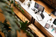 © Wavebreak Media - A modern casual business office setup features a clean desk with tech gadgets