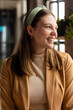 © Wavebreak Media - Young Caucasian woman smiles brightly in a casual business office, with copy space