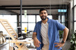 © Wavebreak Media - A young Asian man stands confidently in a modern office, dressed in casual business attire