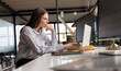 © Wavebreak Media - Young Caucasian woman works intently at her office desk in a casual business environment