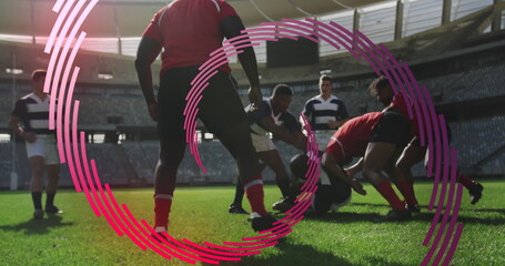 Wall Mural - Image of red line spiral rotating over male rugby players during match